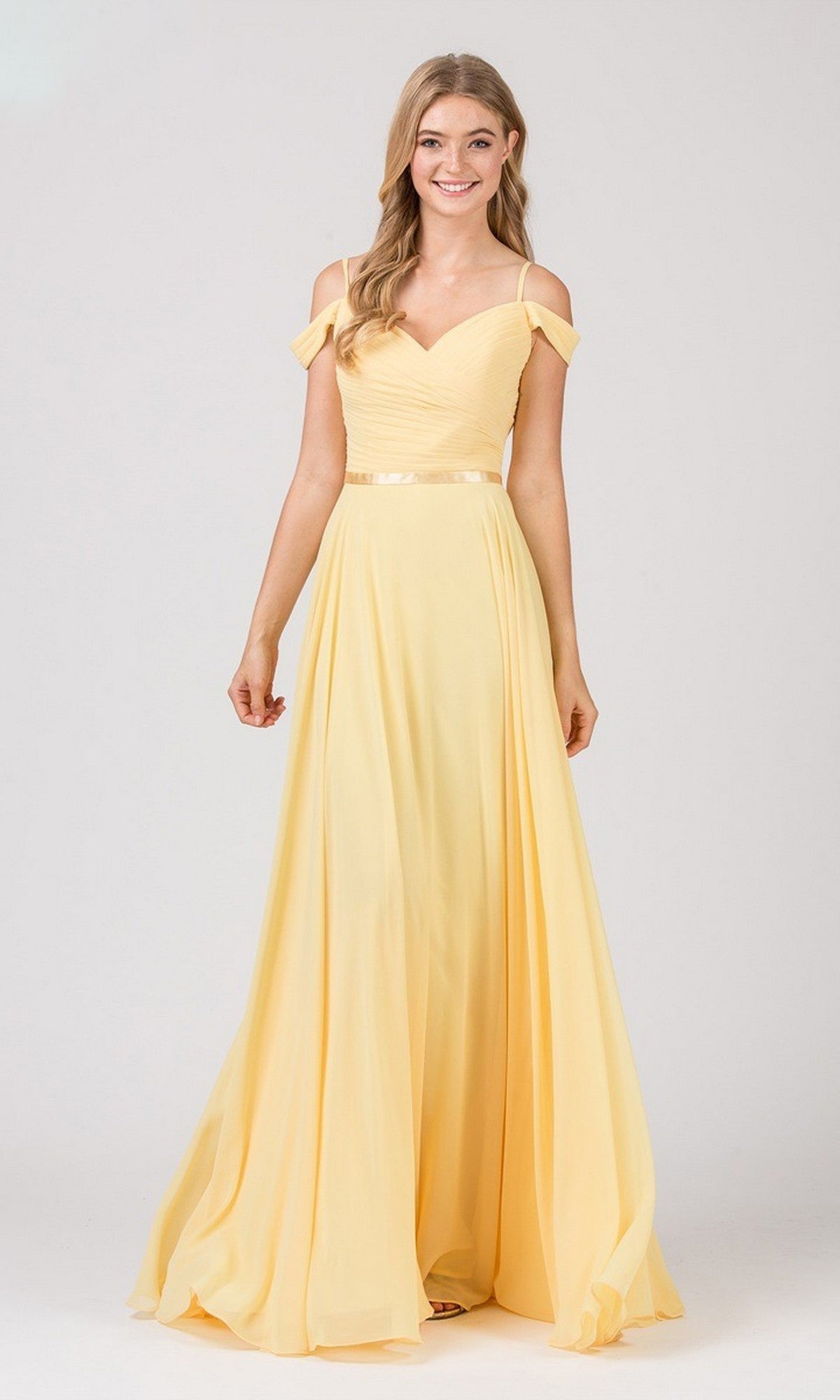 A woman in the yellow Eureka 7611 long prom dress featuring an off-the-shoulder chiffon design with a ruched fitted bodice.
